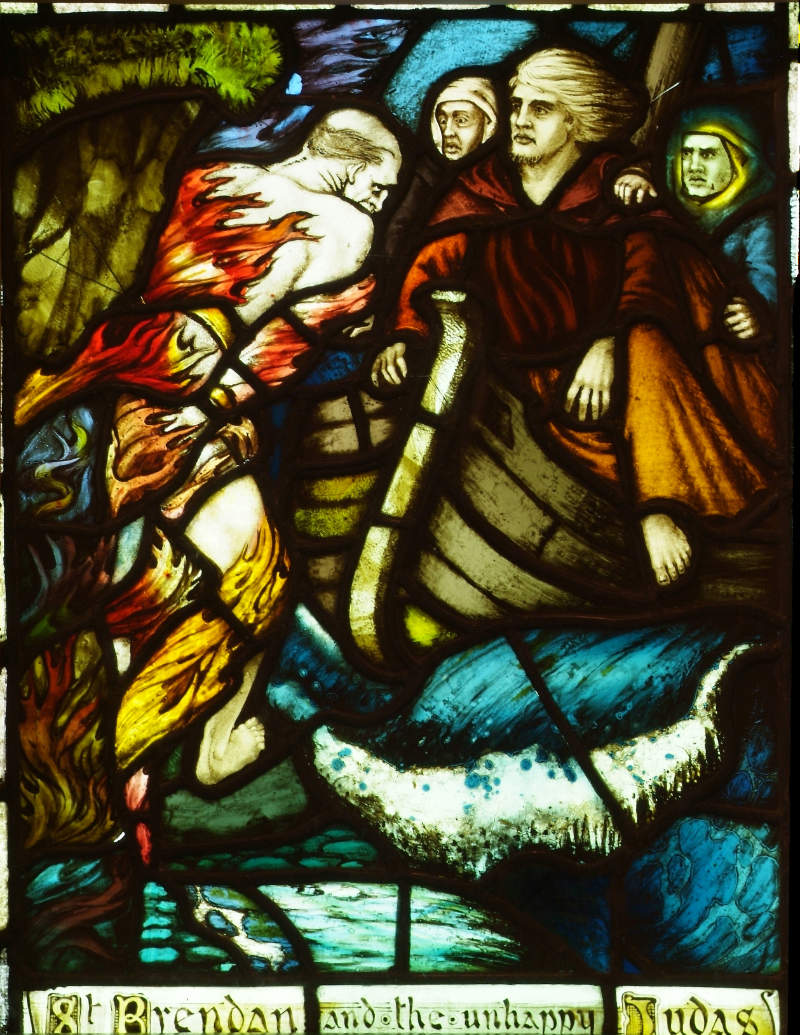 Harry Clarke, The Meeting of St Brendan with the Unhappy Judas, 1911, stained glass | Conserving Harry Clarke: Early Stained Glass | Friday 1 September – Tuesday 21 November 2023 | Crawford Art Gallery | Image: Harry Clarke, The Meeting of St Brendan with the Unhappy Judas, 1911, stained glass | Judas appears to be on the left, and is possibly experiencing the flames of Hell while possibly being bound to a cliff; St Brendan is sailing from the right into the foreground; he's in a boat with two companions; a wave is breaking under the boat, and the title of the image written at the bottom 