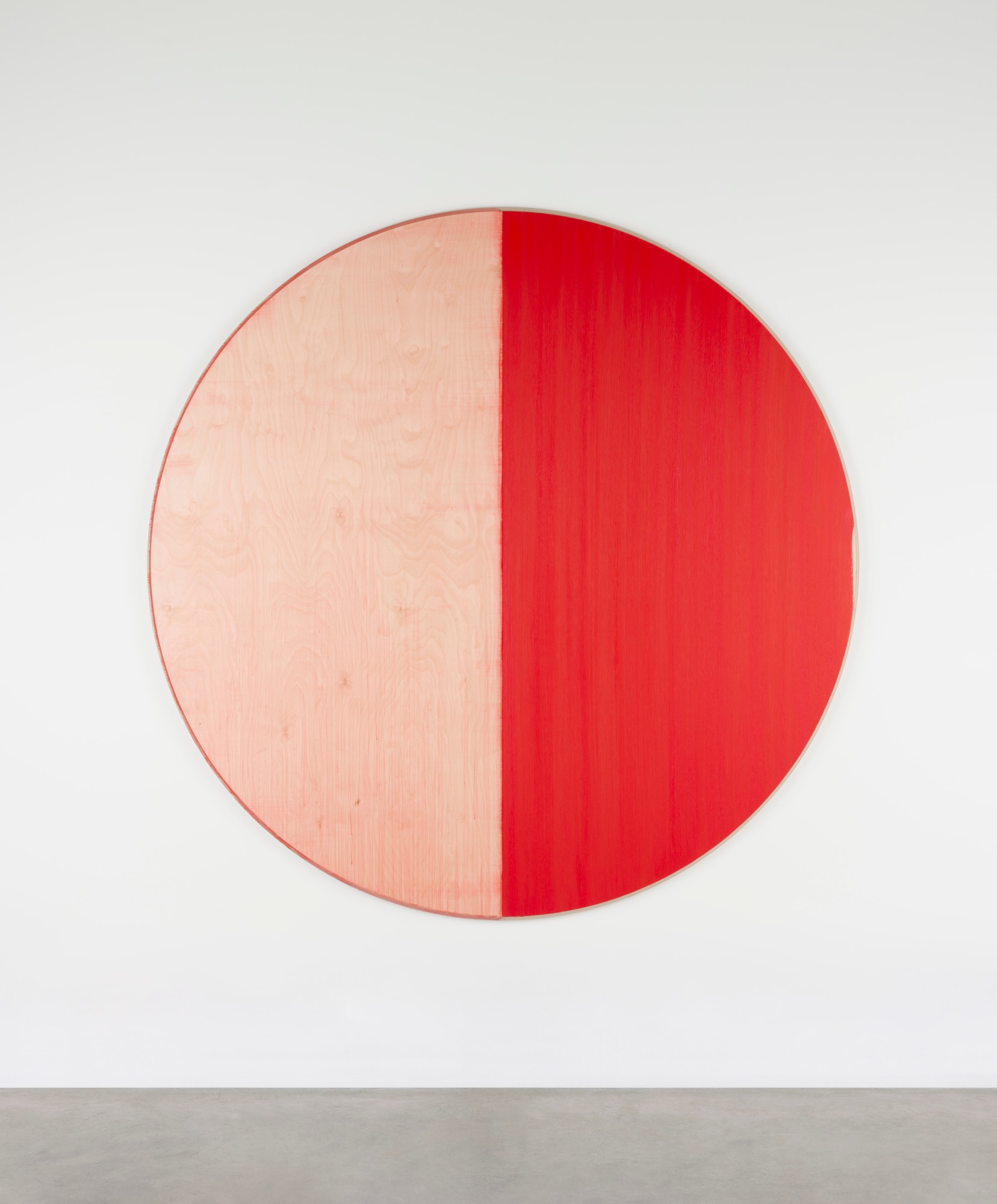 Callum Innes: Untitled Perylene Red, 2023, oil on birch ply, 180 x 180cm | Callum Innes: St Sebastian | Thursday 5 October – Sunday 12 November 2023 | Kerlin Gallery | Image: Callum Innes: Untitled Perylene Red, 2023, oil on birch ply, 180 x 180cm | this is a large circular painting, almost two metres by two metres; there are essentially two colours: the painting is bisected vertically, with the left side being a pale orange – in fact probably bare birch ply – the right side a colour much closer to saturated red 