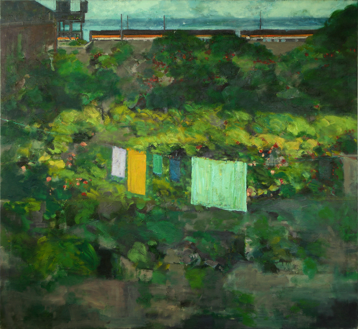 Clement McAleer: The Railway Station Master’s Garden, Oil on Canvas | Clement McAleer: Selected Paintings 1973 – 2023 | Saturday 14 October 2023 – Saturday 3 February 2024 | F.E. McWilliam Gallery | Image: Clement McAleer: The Railway Station Master’s Garden, Oil on Canvas | a painting in a fairly traditional style; we see back gardens of houses, with a clothes line in one supporting five or six items in the shape of sheets or towels; we see clouds in the distance, and what looks very like the tops of a few train carriages in the old CIÉ livery beyond a garden wall 