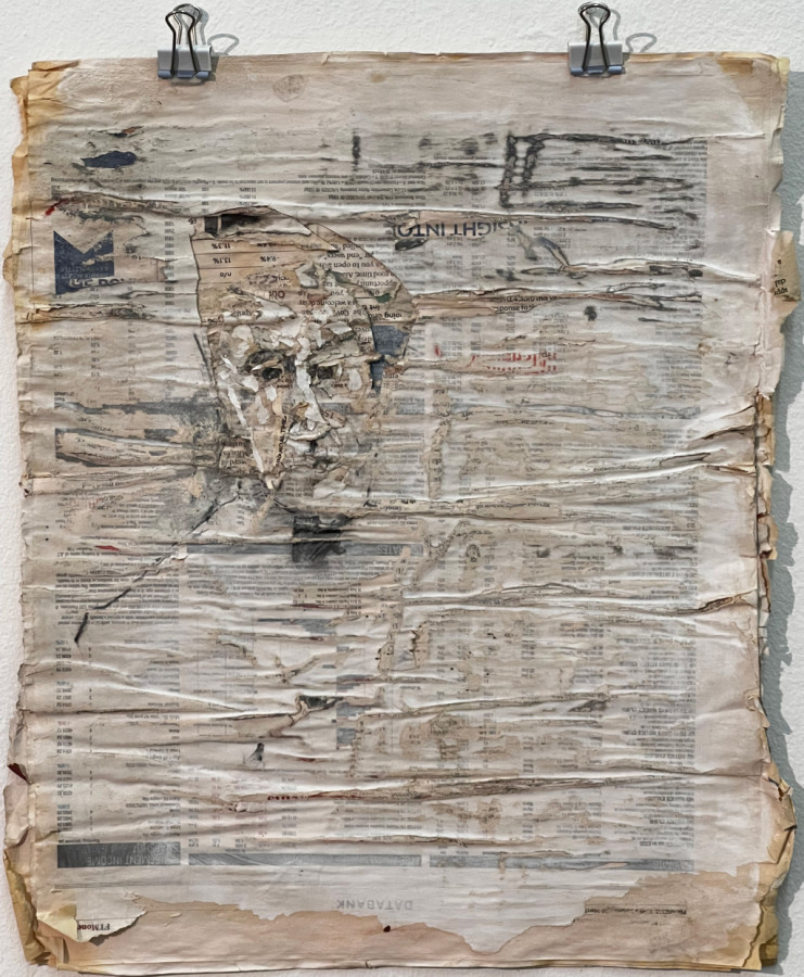 Image: Beth Royds: Flaky self portrait with hat on Financial Times, 2022, newsprint, gesso, graphite, glue | SURVEYOR 2023 | Saturday 2 December 2023 – Saturday 6 January 2024 | Solstice Arts Centre | Image: Beth Royds: Flaky self portrait with hat on Financial Times, 2022, newsprint, gesso, graphite, glue | two black bull-clips at top hold what are presumably multiple pages of the Financial Times covered unevenly in gesso; there is a quirky portrait drawn towards top-left, with not much detail but with black eyes staring out 