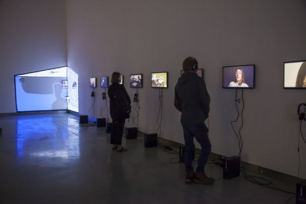 TU Dublin Medua Production and Digital Arts Degree Show 2023 | TU Dublin Media Production and Digital Arts Degree Show | Saturday 18 May – Saturday 25 May 2024 | RUA RED | Image: TU Dublin Medua Production and Digital Arts Degree Show 2023 | photo showing eight screens along one wall and a video projection in the far corner; two people stand at two of the screens 