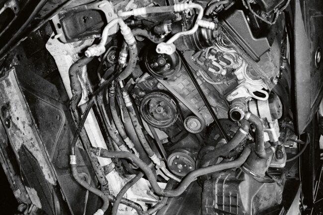 Brian Teeling: blunt, pain at the receptor | Sunday 1 September – Monday 11 November 2024 | Garter Lane Arts Centre | Image: black-and-white photo which seems to be a tilted shot of a car engine, or other vehicle; we see lots of tubes and complexities 