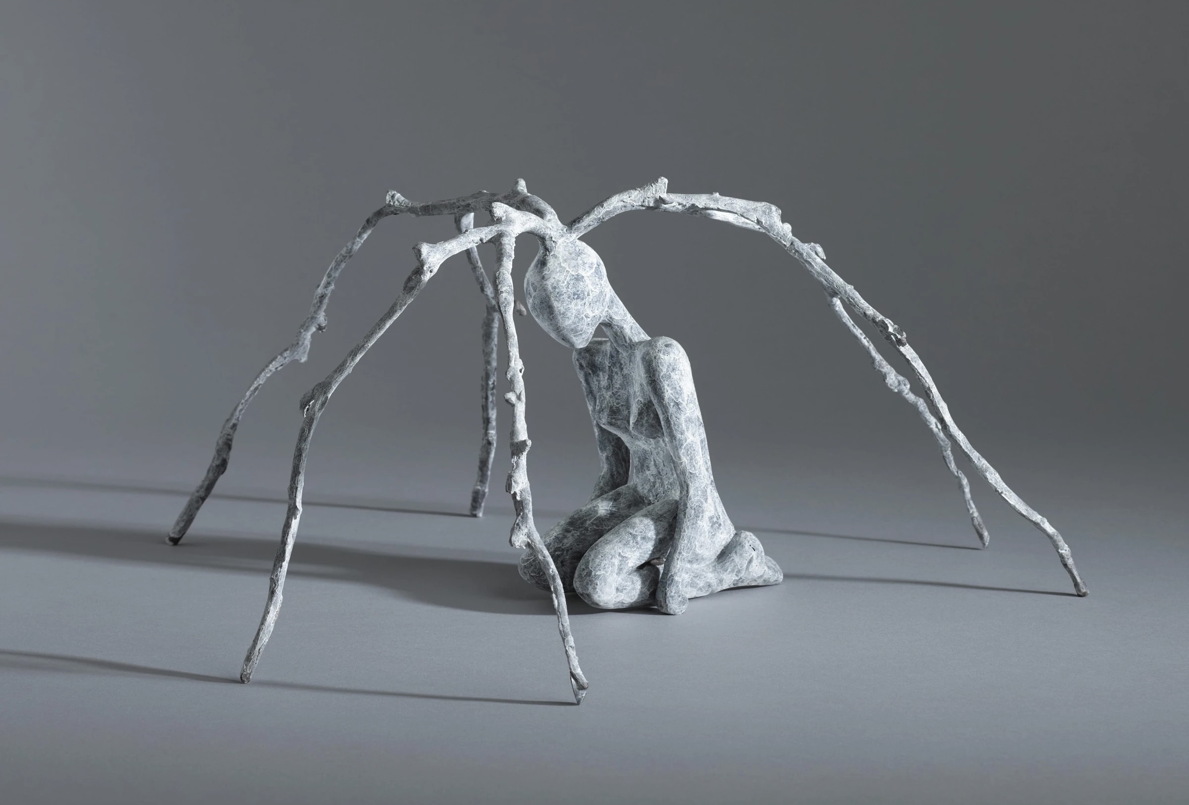 Orla de Brí: Out of the Shadows | Thursday 25 September – Saturday 18 October 2025 | Solomon Fine Art | Image: Orla de Brí: Fragile Architecture, bronze, 19 x 37 x 39cm | photograph of a sculpture; we see a kneeling figure, possibly naked, viewed at about 45 degrees to one side; branches are growing from the figure’s head, six in total, curving up and out and down to the ground; colour scheme overall: grisaille Orla de Brí: Out of the Shadows | Thursday 25 September – Saturday 18 October 2025 | Solomon Fine Art | Image: Orla de Brí: Fragile Architecture, bronze, 19 x 37 x 39cm | photograph of a sculpture; we see a kneeling figure, possibly naked, viewed at about 45 degrees to one side; branches are growing from the figure’s head, six in total, curving up and out and down to the ground; colour scheme overall: grisaille