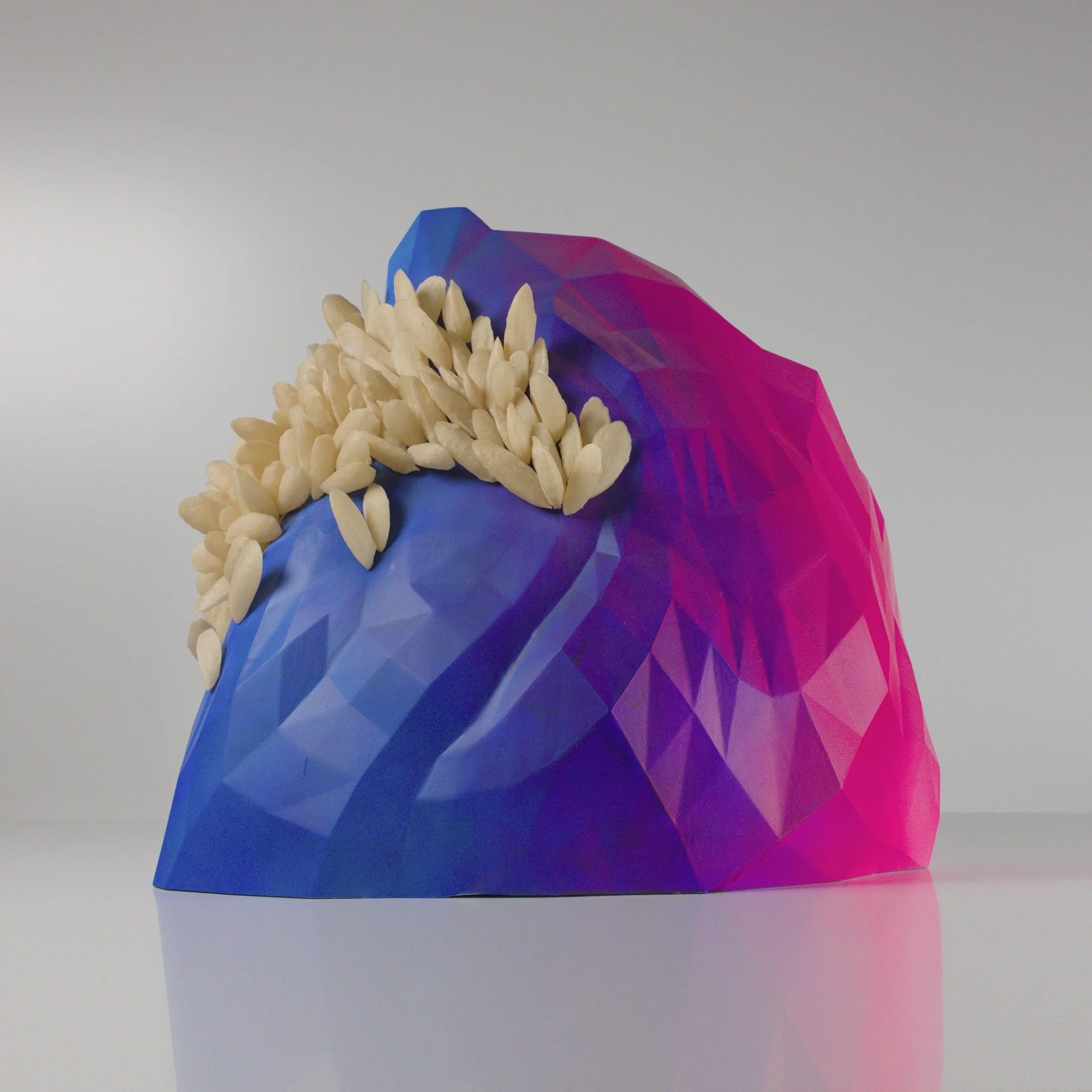 Alan Butler: Ghost Mussels, 2025, Acrylic Paint on PETG (Detail) | Alan Butler: ASSETS | from Friday 7 November | Green On Red Gallery | Image: Alan Butler: Ghost Mussels, 2025, Acrylic Paint on PETG (Detail) | hard to describe; photo (?) of a 3D object that looks somewhat like a very faceted mountain, though the colours appear to be blue and purple into strong pink; on one side of this possible mountain there appears to be a row of seeds, like from a melon, pale, overflowing, like they are coming out of a mouth, upwards; the object is in a grey photographic space  Alan Butler: Ghost Mussels, 2025, Acrylic Paint on PETG (Detail) | Alan Butler: ASSETS | from Friday 7 November | Green On Red Gallery | Image: Alan Butler: Ghost Mussels, 2025, Acrylic Paint on PETG (Detail) | hard to describe; photo (?) of a 3D object that looks somewhat like a very faceted mountain, though the colours appear to be blue and purple into strong pink; on one side of this possible mountain there appears to be a row of seeds, like from a melon, pale, overflowing, like they are coming out of a mouth, upwards; the object is in a grey photographic space