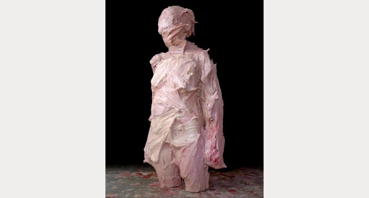 Colin Davidson, Stranger (Tara), 2024-25, Oil and acrylic paint on PLA, 190 x 88 x 55 cm, Image courtesy of the artist. | Colin Davidson: Stranger | Friday 21 November 2025 – Sunday 25 January 2026 | Royal Hibernian Academy | Image: Colin Davidson, Stranger (Tara), 2024-25, Oil and acrylic paint on PLA, 190 x 88 x 55 cm, Image courtesy of the artist. | photo of a sculpture of a figure who is modelled from head to above the knees; it looks like heavily applied plaster, coloured mostly light pink; the background is mostly black; the sculpture is standing on a patterned surface  Colin Davidson, Stranger (Tara), 2024-25, Oil and acrylic paint on PLA, 190 x 88 x 55 cm, Image courtesy of the artist. | Colin Davidson: Stranger | Friday 21 November 2025 – Sunday 25 January 2026 | Royal Hibernian Academy | Image: Colin Davidson, Stranger (Tara), 2024-25, Oil and acrylic paint on PLA, 190 x 88 x 55 cm, Image courtesy of the artist. | photo of a sculpture of a figure who is modelled from head to above the knees; it looks like heavily applied plaster, coloured mostly light pink; the background is mostly black; the sculpture is standing on a patterned surface