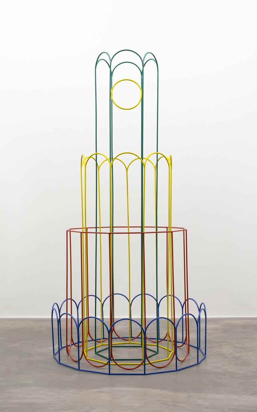 Isabel Nolan: Splendid and Pointless, 2025, 10mm solid round steel, paint, 4 elements, 2/2 from a variable edition of 2, each edition in different colours; 240.5 x 119.7 x 119.7 cm / 94.7 x 47.1 x 47.1 in | Isabel Nolan: “Look at the Harlequins!” | Saturday 11 October – Saturday 22 November 2025 | Kerlin Gallery | Image: Isabel Nolan: Splendid and Pointless, 2025, 10mm solid round steel, paint, 4 elements, 2/2 from a variable edition of 2, each edition in different colours; 240.5 x 119.7 x 119.7 cm / 94.7 x 47.1 x 47.1 in | an object that looks like a cross between something that you might find in a playground and a lighthouse or church steeple; curves of bent steel painted bright colours, creating a series of concentric circular shapes, getting narrowe and taller as we move inwards 