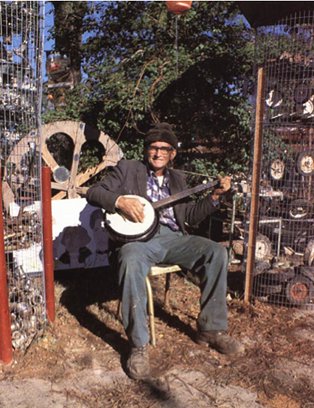 Howard with banjo, 1978; courtesy of Victor Faccinto | Reverend Howard Finster: Message Posters | Friday 3 February  – Wednesday 28 March 2012 | Douglas Hyde Gallery