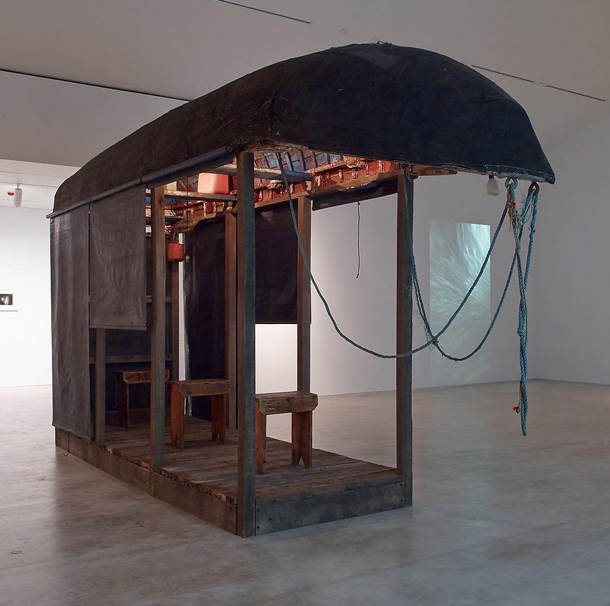 Dorothy Cross / Tabernacle, 2013 / Currach, shed, wood, roller blinds, mixed media, video / 270 x 522 x 126 cm / Collection Irish Museum of Modern Art / Donation, 2015 / IMMA.3881 | IMMA Collection: Coast-lines | Friday 13 October 2017  – Sunday 16 September 2018 | IMMA