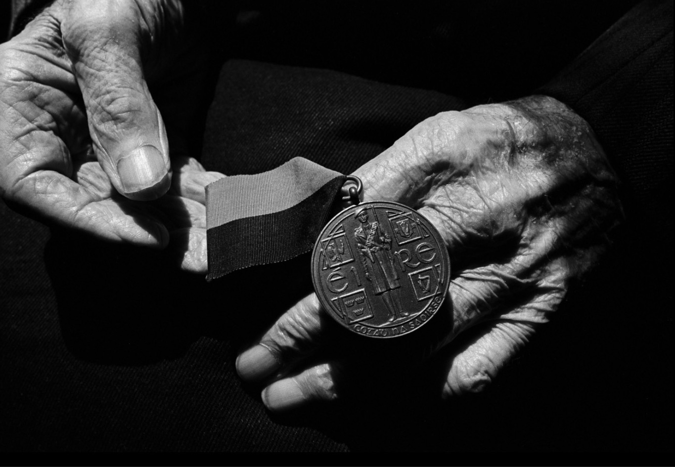 Seamus Murphy: The hands of Batt Moriarty at home in County Cork holding his ‘Black and Tan’ medal awarded to IRA men who fought in Ireland's War of Independence with Britain. Batt Moriarty -Cork No. 4 Brigade. Intelligence Officer. IRA 1918-1923. | Seamus Murphy: Citizens | Friday 20 November 2020  – Friday 26 February 2021 | The Source Arts Centre