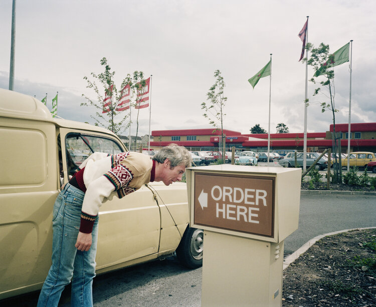 Martin Parr: A drive-thru McDonald’s, Nutgrove Shopping Centre, Dublin, 1986 | Parr’s Ireland: 40 Years of Photography | Saturday 26 June  – Saturday 4 September 2021 | Photo Museum Ireland