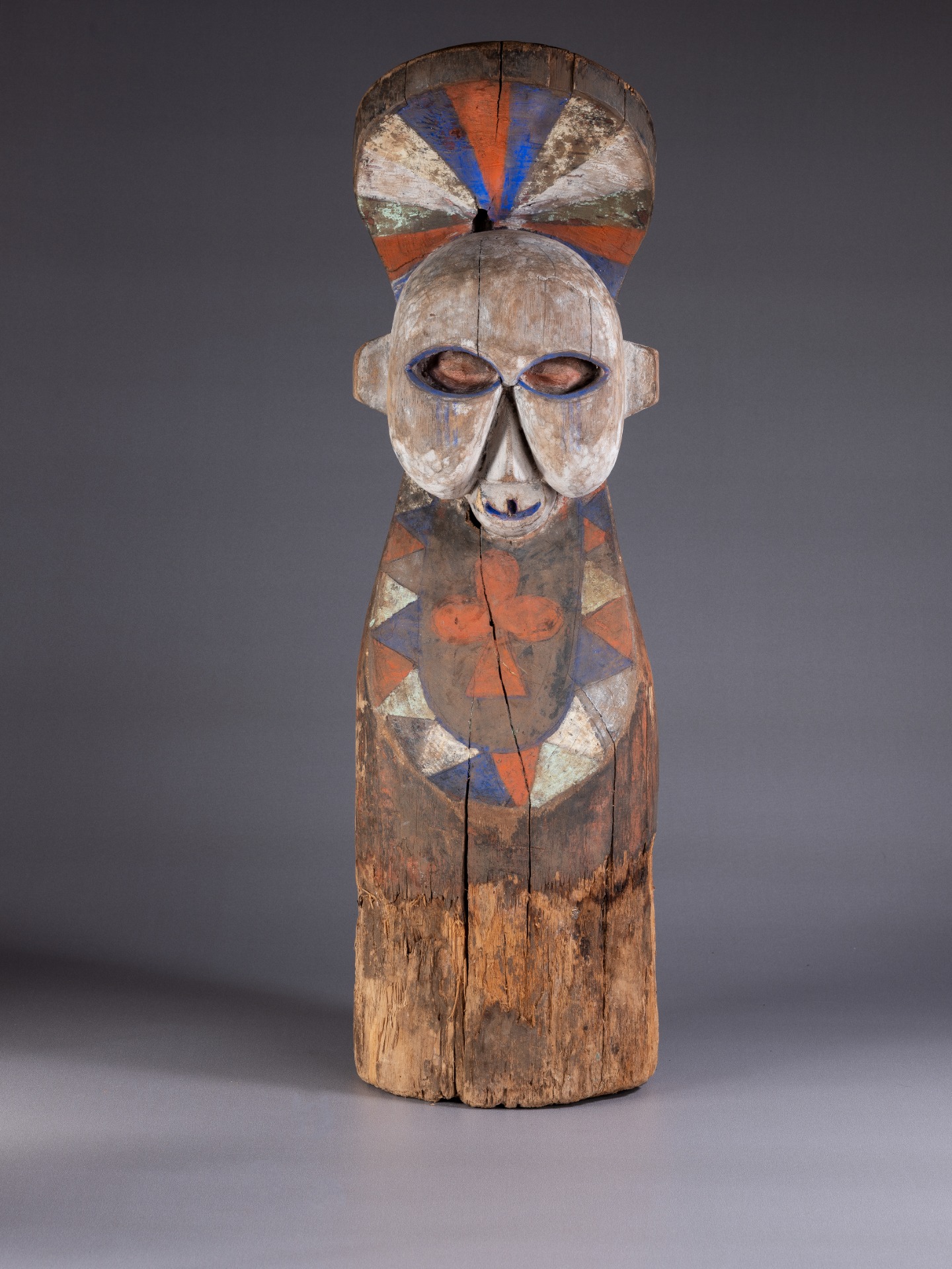 Unseeing Traces | Saturday 15 April  – Sunday 11 June 2023 | IMMA | Image: a totemic (?) half-figure in carved, painted wood against a neutral grey photographic setting 
