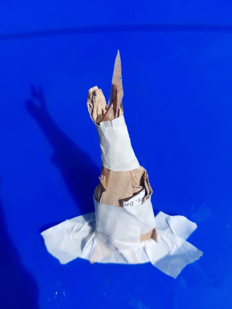 Anna Spearman, Kian Benson Bailes & Orla McHardy: hashtag WIP | Friday 14 April  – Friday 2 June 2023 | Roscommon Arts Centre | Image: photo of a 3D construction in paper and cardboard that looks something like a wizard's hat, in terms of shape 