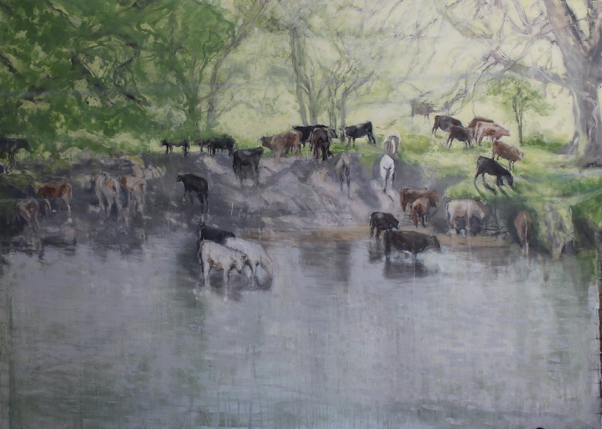 Bernadette Kiely, Stay silent and still [survival of the fittest], 2023, oil on canvas, 158 x 213 cm | Bernadette Kiely: Survival of the Fittest – [The Answer is] Blowing in the Wind | Friday 16 June  – Saturday 8 July 2023 | Taylor Galleries | Image: Bernadette Kiely, Stay silent and still [survival of the fittest], 2023, oil on canvas, 158 x 213 cm – realistic depiction of cows down by a river (among trees by the river, on the river bank, in the river apparently drinking the water; there‘s a sense of hazy sunshine 