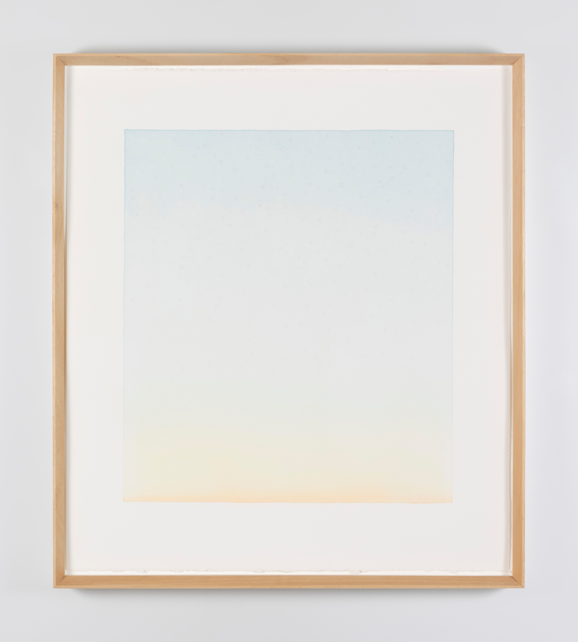 William McKeown, Freedom Drawing – Starlings #6, 2006, watercolour on paper, 60.5 x 53.3 x 3 cm framed | William McKeown: An Open Room | Wednesday 30 August  – Saturday 30 September 2023 | Kerlin Gallery | Image: William McKeown, Freedom Drawing – Starlings #6, 2006, watercolour on paper, 60.5 x 53.3 x 3 cm framed – very delicate painting, with the top a pale blue which fades gradually through white then very pale yellow to finally, at the very bottom, the beginning of orange 