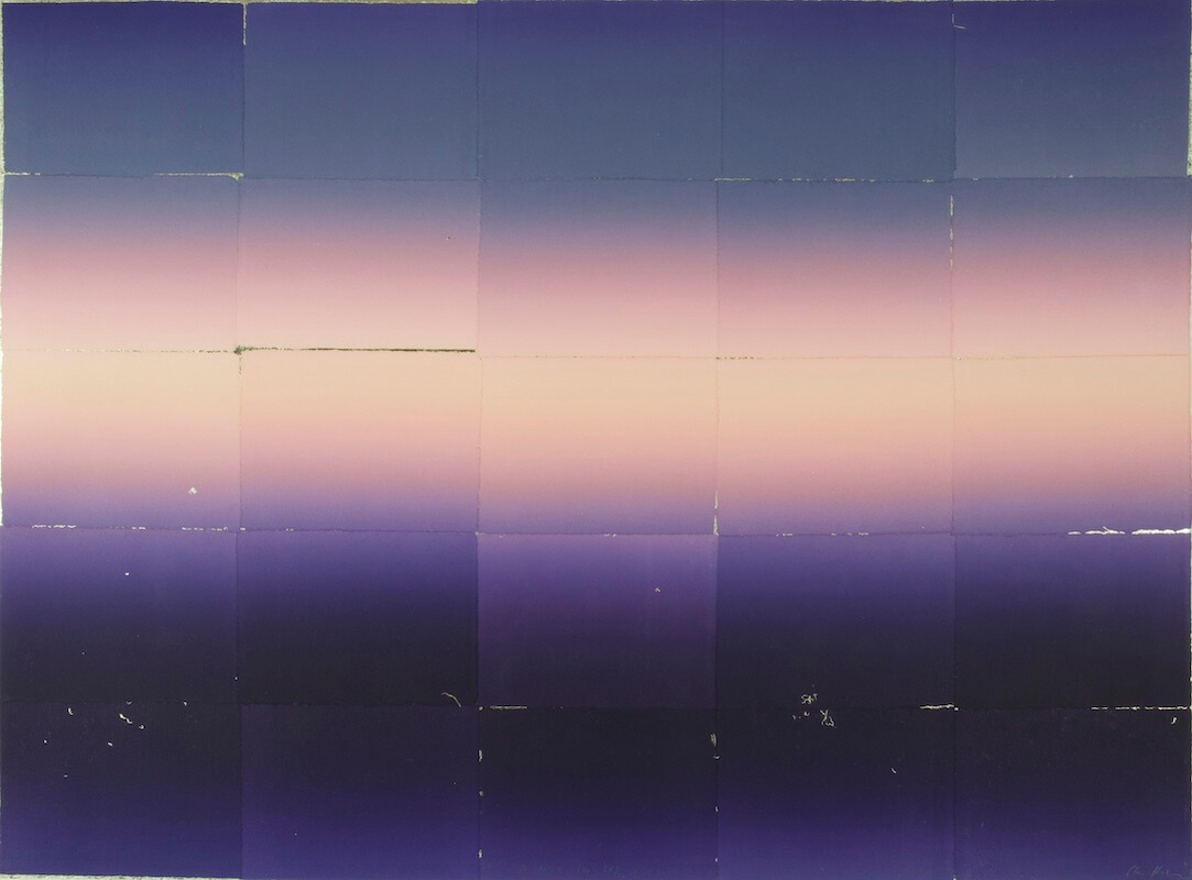 Clare Henderson, To Meet The Sky I, composite monoprint with chine collé and platinum leaf, 80 x 110cm | Clare Henderson & James Kirwan: Thin Places | Saturday 30 September  – Saturday 21 October 2023 | SO Fine Art Editions | Image: Clare Henderson, To Meet The Sky I, composite monoprint with chine collé and platinum leaf, 80 x 110cm | if it’s read as a landscape or seascape, we see a glowing pale-yellow-to-reddish-orange horizon which takes up about a third of the image, stretching left to right; this ‘sunset’ blurs above and below into shades of purple and blue; all hues are very blurred, so that they blend easily into their neighbours; we also see a pattern of rectangles superimposed onto the image; it’s as though the whole image had been folded vertically and horizontally and then opened out again 