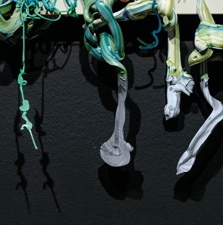 Emma Roche: LOOP | Tuesday 17 October  – Saturday 25 November 2023 | Wexford Arts Centre | Image: what are apparently solidified (but still flexible) stands of paint hang down over a dark-grey surface, casting shadows on it; most strands are multi-coloured in long streaks; colours range through blue and turquoise to pale green and white; some of thinner strands are only of one colour; most of the strands appear to be twisted around into themselves 