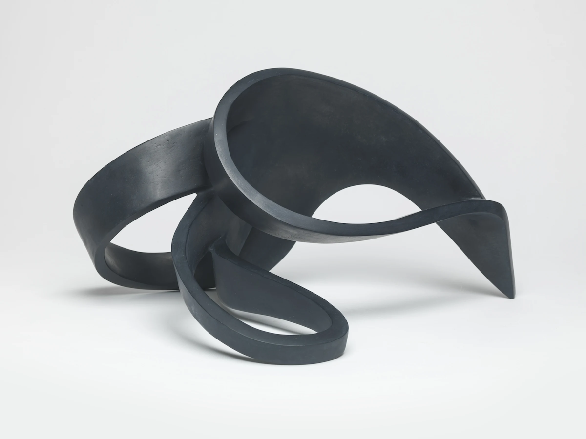 Eilis O’Connell: Sprawl, 2021, bronze, 25 x 36 x 46cm, edition of 5 | Eilis O’Connell: Hardware / Software | Saturday 28 October  – Saturday 18 November 2023 | Solomon Fine Art | Image: Eilis O’Connell: Sprawl, 2021, bronze, 25 x 36 x 46cm, edition of 5 | photo of a matt-black object which resembles a sort of conjoined Möbius strip; the environment is otherwise pure white with gentle shadows from the artwork 