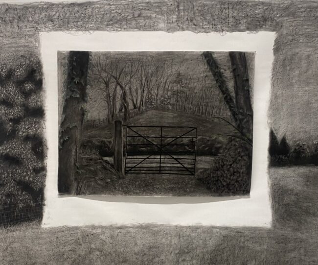Elaine Somers-Cashen | Experiments in First View – Expanded Studio 2024 | Tuesday 23 January  – Saturday 3 February 2024 | Garter Lane Arts Centre | Image: Elaine Somers-Cashen | pencil or charcoal drawing (or similar) ofa rural scene, though it is also of one scene inserted into what is another landscape – there a wide edge, like that on a frame, with some hints of a field, then white space a bit narrower than the frame, then a continuation of the frame scene or, more likely, a new scene which depicts a view towards a farm-style gate (which is possibly not very effective – there’s a big gap to one side before it meets what may be a stone wall; across a narrow road we see a wall or hedge, then a field which seems to be triangular and perhaps rising; it is bounded by wintry trees, and there is a hint of a church’s steeple at the top 