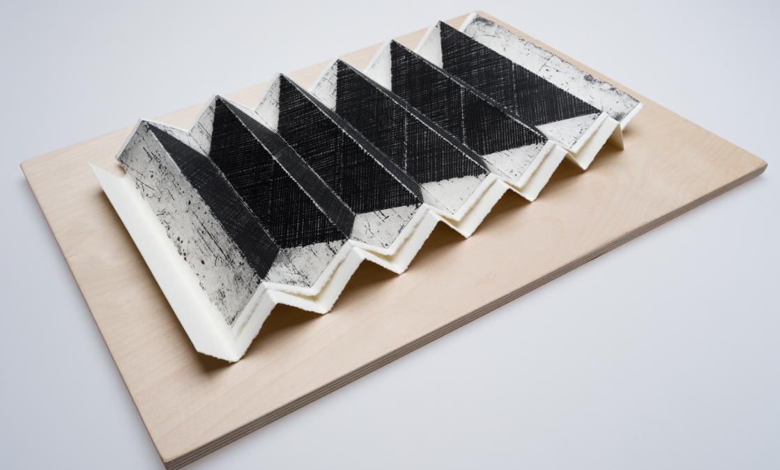 John Graham, Folded Figure 1, 2022, Folded etching on folded paper on plywood, 35 x 5 x 50cm, courtesy of the artist | John Graham: Hold to the now the here through which all future plunges to the past | Friday 16 February  – Sunday 24 March 2024 | Royal Hibernian Academy | Image: John Graham, Folded Figure 1, 2022, Folded etching on folded paper on plywood, 35 x 5 x 50cm, courtesy of the artist | the title pretty much describes the piece; photo of a rectangular sheet of wood (ply?) on which we see a concertina-ed print; the folds appear to correspond to a 2D depiction of a concertina-ed shap, and the concertina-ing seems to be on top of an underlying concertina-ed piece of paper…  