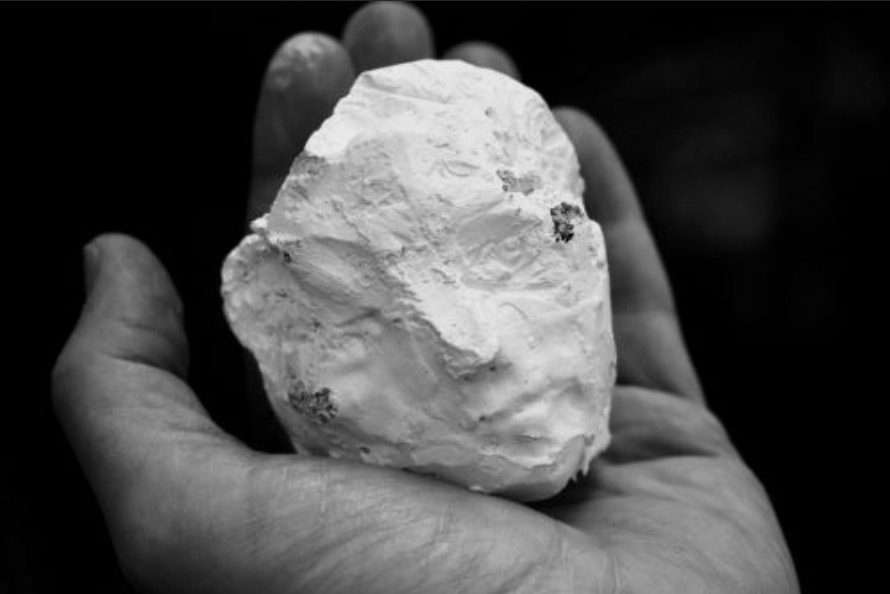 Andy Parsons: hand-held sculpture | Caring for creativity | Wednesday 1 May  – Sunday 30 June 2024 | Roscommon Arts Centre | Image: Andy Parsons: hand-held sculpture | black-and-white photo of a left hand holding a lump of white plaster in which we can make out a half-hidden face 