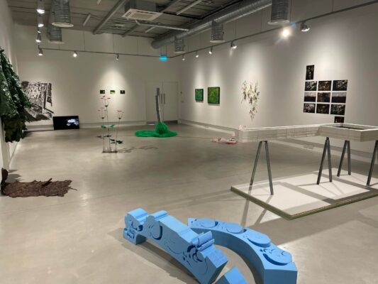 Hivernal | Friday 1 November  – Saturday 21 December 2024 | Roscommon Arts Centre | Image: installation shot in gallery space; image quite blurry; semi-industrial shapes on the floor near the camera, painted baby-blue; other 3D artworks arranged around the floor space, plus 2D artworks on the walls; each work well lit 