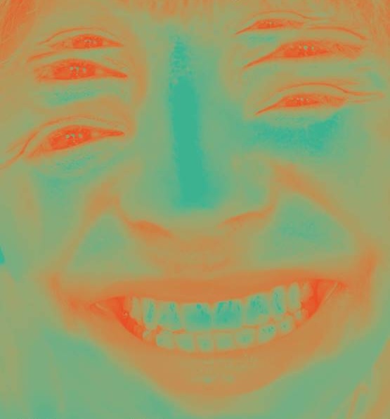 Kian Benson Bailes: Culchie boy, I love you / Grá mo chroí thú, mo chábóigín féin | Friday 24 January  – Sunday 30 March 2025 | Limerick City Gallery | Image: multiply-exposed photo of a smiling face – the eyes appear in three pairs, each pair above the other; the coloration is green to orange; good teeth 