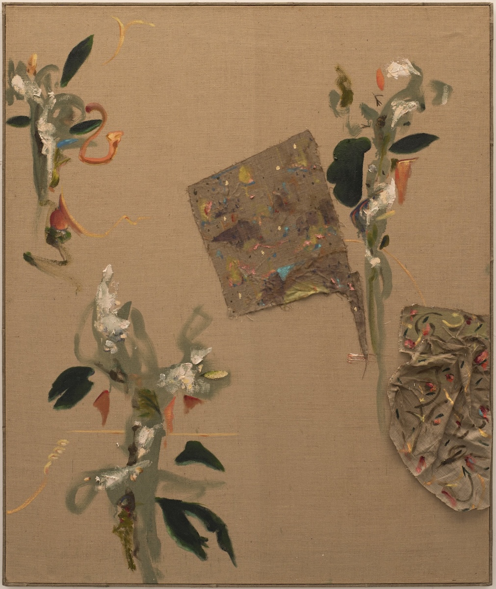 Damien Flood: Torn Landscape, 2024, oil on hessian, oil on raw linen, rosemary, staples 153 x 127 cm | Damien Flood: “As Above, So Below“ | Friday 7 February  – Friday 11 April 2025 | Green On Red Gallery | Image: Damien Flood: Torn Landscape, 2024, oil on hessian, oil on raw linen, rosemary, staples 153 x 127 cm | most of the canvas is not painted, and it appears a textured warm brown-tan; painted onto it we see three shapes that are roughly flower-liie – leaves of dark green, other leaves (?) of a pale greyish-green, orange shapes, textured white paint; two pieces of other canvas – perhaps the raw linen, which is fairly dark – appear to have been stuck to the first canvas; these pieces are oddly shaped – one almost a square and somewhat centred on the image, the other fairly crumpled and attached towards the bottom right; this second piece seems to be decorated with a flower motif 