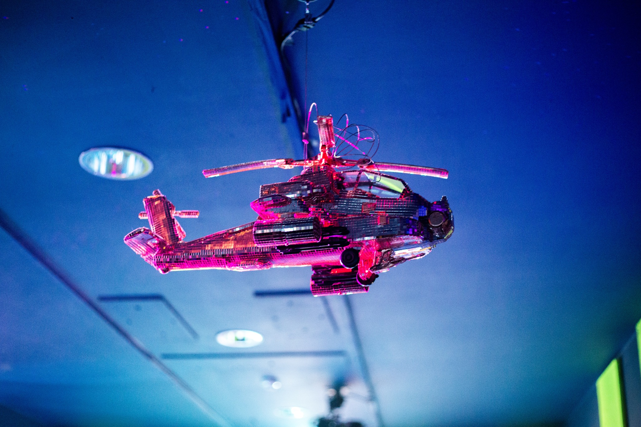 Array Collective: The Goose and the Common | Saturday 15 February  – Saturday 3 May 2025 | Rua Red | Image: photo of a pink helicopter made out of funky material, viewed from below and to one side, with a blue ceiling behind it; it’s probably not very big 
