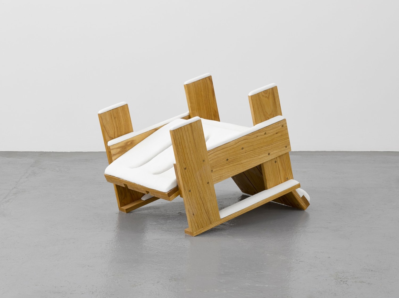 Ryan Gander: Overturned Rietveld chair after a snow flurry, 2017, marble resin, 60 x 62 x 84 cm / 23.6 x 24.4 x 33.1 in | Pictures of You | Friday 4 July  – Saturday 23 August 2025 | Kerlin Gallery | Image: Ryan Gander: Overturned Rietveld chair after a snow flurry, 2017, marble resin, 60 x 62 x 84 cm / 23.6 x 24.4 x 33.1 in | photo taken in a gallery setting of what looks like a fairly chunky outdoor chair upended and covered in snow 
