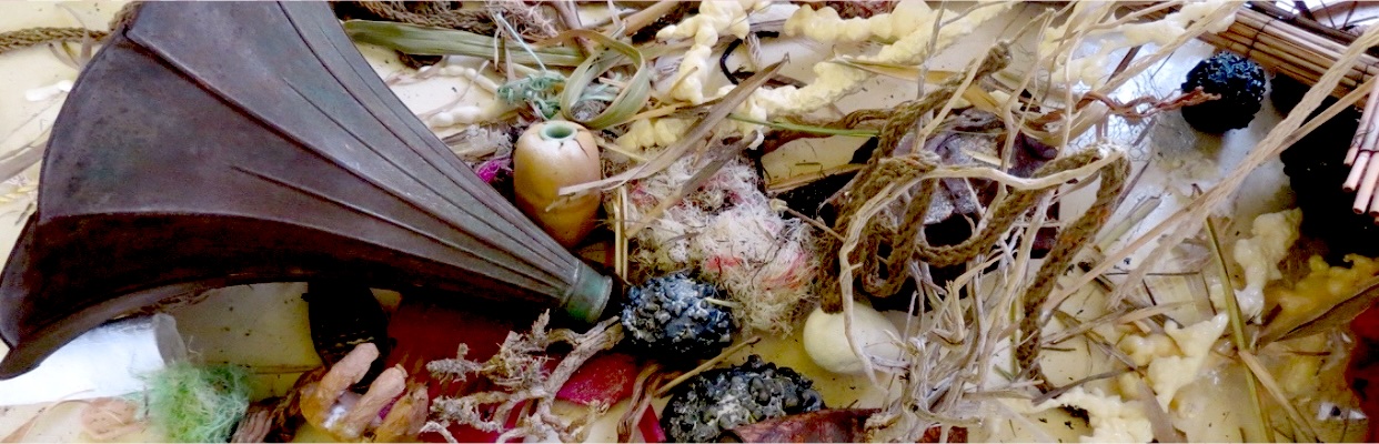 Breaking the Patterns | Saturday 11 October  – Saturday 25 October 2025 | GOMA Gallery of Modern Art | Image: photo of a jumbled mass of stuff, much of it looking vegetable-ish, but including an old megaphone or something of that ilik; there seems to be a hand-shape towards the bottom left; twisted loose rope, plant leaves, reeds, was? 