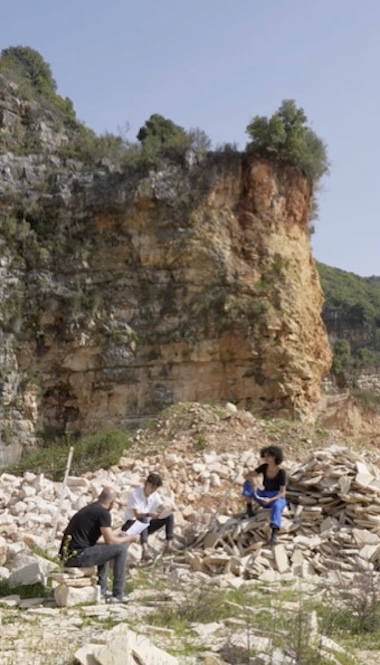 Marwa Arsanios, Who is Afraid of Ideology? Part 4: Reverse Shot, 2022, digital video, 35 mins, video still. Courtesy of the artist. | Marwa Arsanios: Who Is Afraid of Ideology? Part 4: Reverse Shot |   to Sunday 26 October | Limerick City Gallery | Image: Marwa Arsanios, Who is Afraid of Ideology? Part 4: Reverse Shot, 2022, digital video, 35 mins, video still. Courtesy of the artist. | cropped image of three people sitting in what looks like a quarry, with a bluff in the background; hot sunny day, having the chats