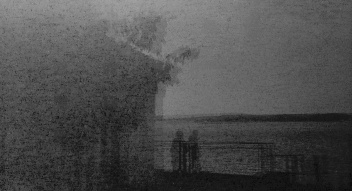 Artem Trofimenko: FXILE | Artem Trofimenko: FXILE | Saturday 10 January  | SIRIUS | Image: Artem Trofimenko: FXILE | this appears to be a double-exposed black-and-white photo; it appears to show two people standing at some railings looking out to sea Artem Trofimenko is a Ukrainian Irish artist based in Cork City. His practice encompasses moving image, performance, photography, and sound, employing the body through endurance and spirituality. He experiments with analogue film, darkroom processes, found light, and sound design.
Artem has a background in theatre and dance, including Butoh, which informs his engagement with various media and investigations of themes of displacement. He explores how memory and perception inhabit the body, as well as how the act of seeing constitutes a form of exile.
FXILE is a somatic exploration of the SIRIUS building and its surroundings. It features audio-visual elements and live outputs that examine the relationships among self and architecture, stillness and movement, and land and water. The works elicit moments of communion…”