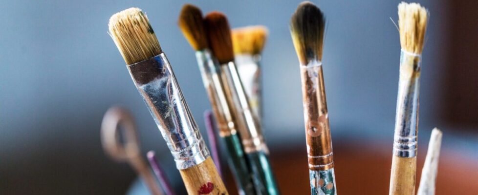 Artist paint brushes and paint cans