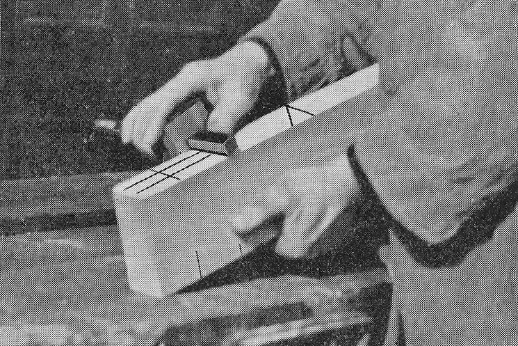 illustration from ‘Joinery (Teach Yourself Series): A Practical Guide to Woodworking’, by T. O. Howard (1951) | Jan McCullough at Tea Houses | Saturday 14 March  – Saturday 21 March 2026 | Butler Gallery | Image: illustration from ‘Joinery (Teach Yourself Series): A Practical Guide to Woodworking’, by T. O. Howard (1951) | black-and-white photo of just sleeved lower arms and hands of someone hold a plank of wood and doing something with a metal device which is held in the right hand; hard to be certain, but it looks as though some black lines have been added afterwards to the image 