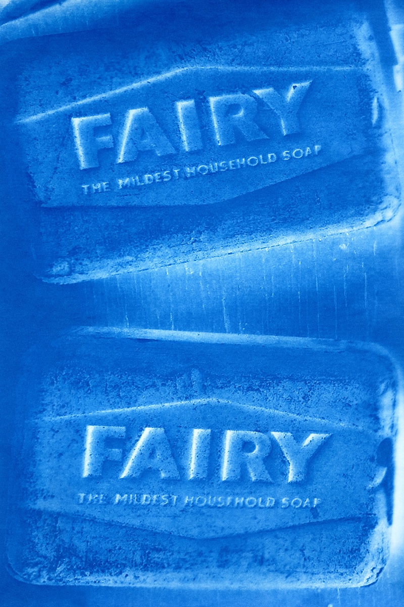 Breda Lynch: Hellbound | Saturday 13 June  – Saturday 11 July 2026 | GOMA Gallery of Modern Art | The image appears to be a photo of two bars of Fairy soap, though there is a very strong blue cast and the soap surfaces appear to be distressed; the bars are presented one in the top half of the tall photo, one in the bottom half, slightly rotated with respect to each other; the embossed text on the soaps is “FAIRY THE MILDEST HOUSEHOLD SOAP” with “FAIRY” in relatively very large letters; font is sans-serif and all uppercase 