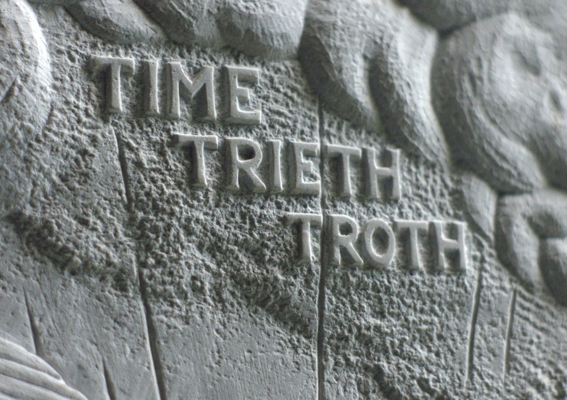 Grace Weir, Time Tries All Things, 2019, Film Still | The Future Is Open | Saturday 20 June  – Saturday 29 August 2026 | Solstice Arts Centre | Grace Weir, Time Tries All Things, 2019, Film Still | the words ‘TIME TRIETH TROTH’ appear to be carved into white marble, in relief; the letters, all in caps and serif font, cast shadows caused by a light source coming from top right; there are swirls above and to the right, some lines, some texture 