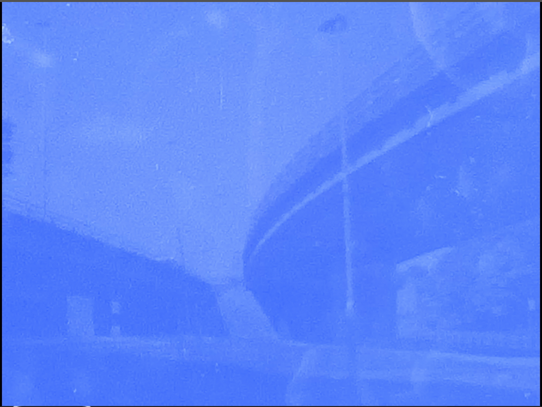 Kai Fiáin: Concrete & Film | Saturday 25 April  – Wednesday 10 June 2026 | Uillinn: West Cork Arts Centre | Kai Fiáin | photographic image of a highway / motorway flyover, seen from below; it sweeps by, up and to the right as we look, and it appears to have a matching segmet heading off to our left; the image overall has a blue cast, effectively eliminating all other colours, just lighter or darker (not very dark though) blue; the image appears to be distressed as well – marks of various sorts 