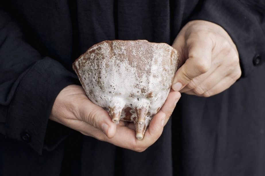 Vanessa Donoso López | Vanessa Donoso López | Friday 24 July  – Sunday 20 September 2026 | Temple Bar Gallery + Studios | Vanessa Donoso López | photograph or video still; we see just the hads of a dark-clad figure; the right hand is holdig what seems to be an udder with maybe four teats, and fashioned possibly in bronze with an uneven coating of white